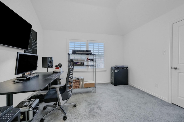 office space with light colored carpet, baseboards, and vaulted ceiling