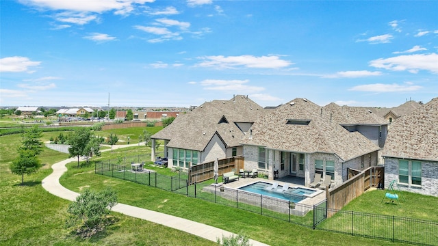 782 Corner Post Path, Celina, TX 75009 - rear view of property featuring a patio, stone siding, roof with shingles, and a pool with connected hot tub