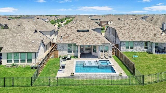 782 Corner Post Path, Celina, TX 75009 - back of house with a residential view, a pool with connected hot tub, a patio area, and stone siding