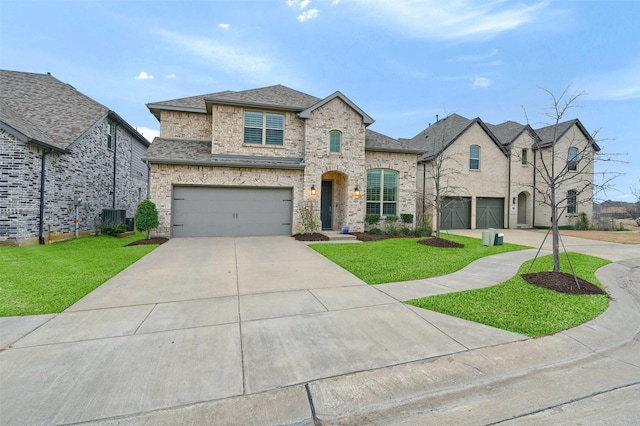 french provincial home featuring brick siding, an attached garage, a shingled roof, a front yard, and driveway