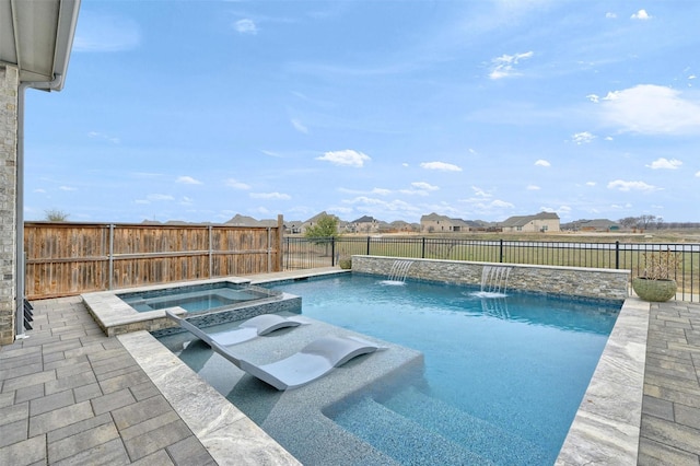 view of swimming pool featuring a fenced backyard and a pool with connected hot tub