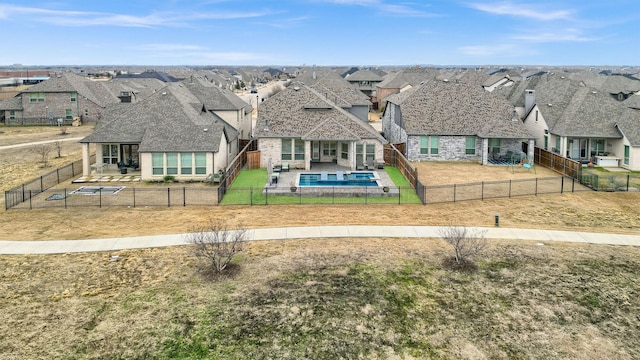 exterior space with a residential view, a fenced backyard, and a patio area