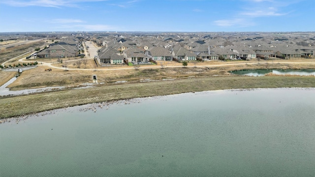 bird's eye view featuring a residential view and a water view