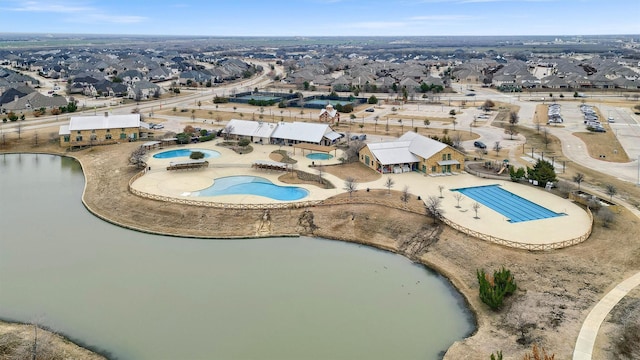 drone / aerial view with a residential view and a water view