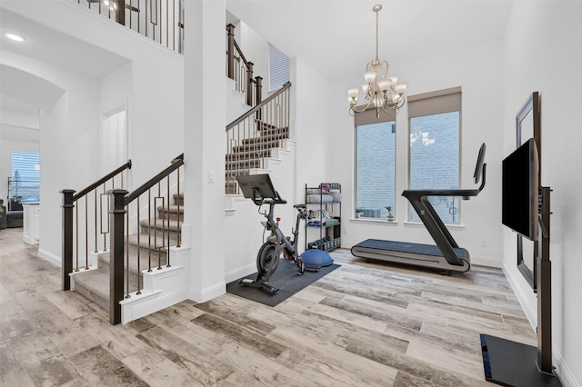 782 Corner Post Path, Celina, TX 75009 - exercise area with wood finished floors, arched walkways, a chandelier, baseboards, and a towering ceiling