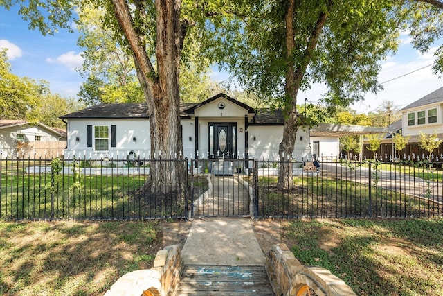 view of front of home featuring a fenced front yard, a front lawn, and a gate