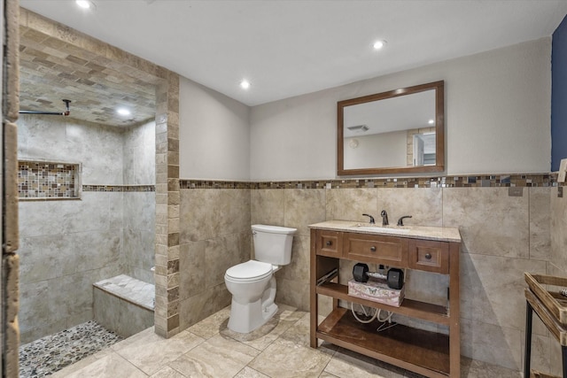 full bathroom with toilet, walk in shower, vanity, tile walls, and recessed lighting