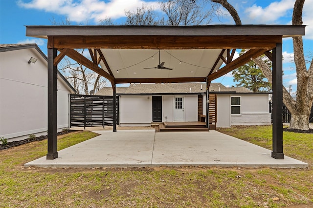 view of patio / terrace featuring ceiling fan and fence