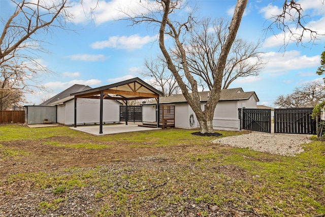 back of property featuring a patio, a gate, fence, a gazebo, and stucco siding