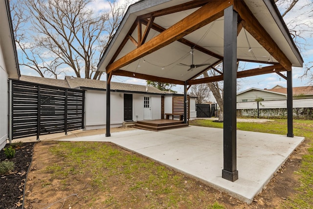 view of patio / terrace featuring ceiling fan, fence, and a gazebo