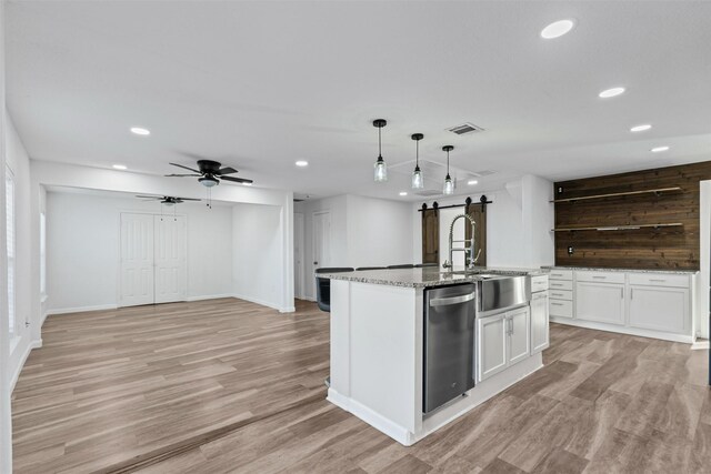 kitchen with decorative backsplash, stainless steel range with electric stovetop, fridge, wall chimney range hood, and a kitchen bar