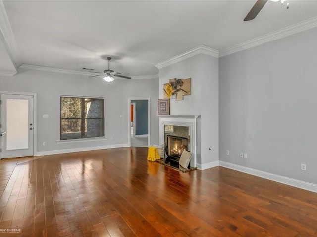 unfurnished living room with ceiling fan, ornamental molding, a fireplace, and wood-type flooring