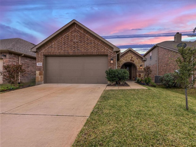 view of front facade featuring a front lawn, brick siding, stone siding, and driveway