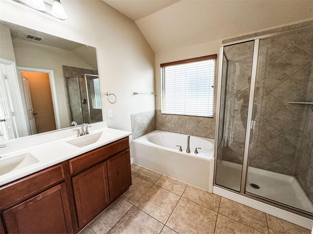 full bathroom with a shower stall, a garden tub, lofted ceiling, and a sink