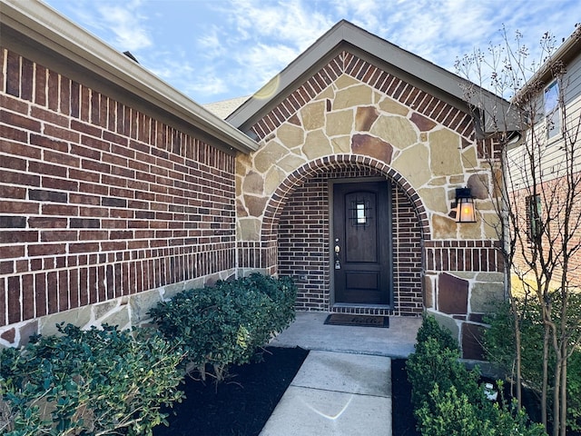 property entrance featuring brick siding