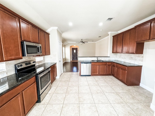 kitchen with light tile patterned floors, a ceiling fan, visible vents, dark stone counters, and appliances with stainless steel finishes