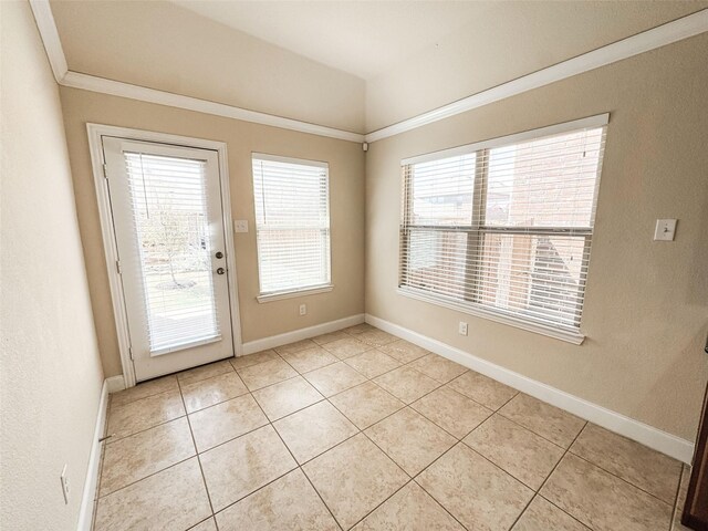 entryway with light tile patterned floors, baseboards, and ornamental molding