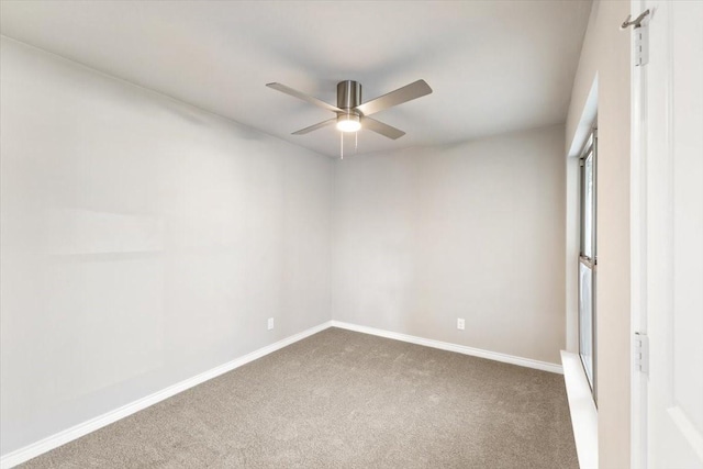 unfurnished bedroom with ceiling fan, carpet flooring, and baseboards