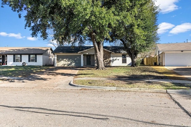 ranch-style house featuring a garage, fence, and concrete driveway