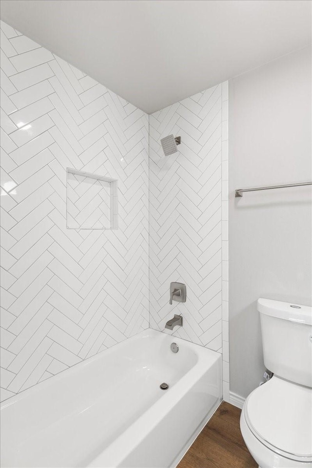 full bathroom featuring baseboards, shower / tub combination, toilet, and wood finished floors