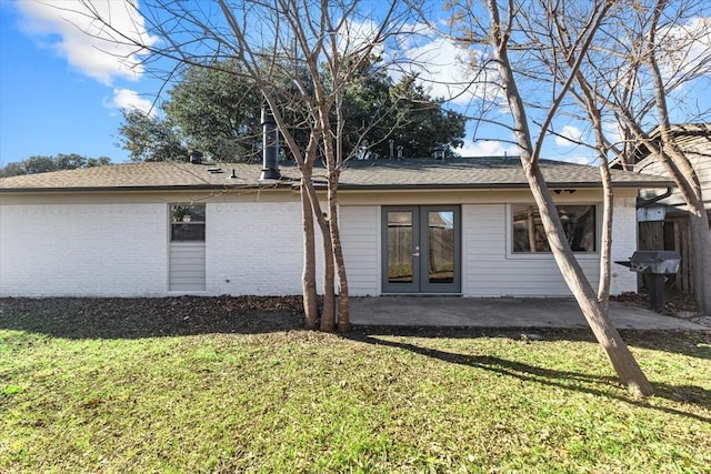 back of house with a yard, french doors, a patio, and brick siding