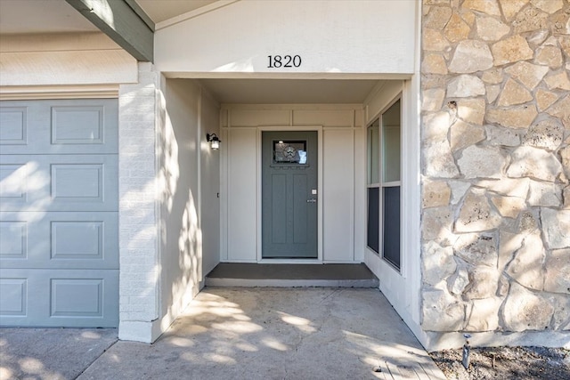 entrance to property featuring stone siding