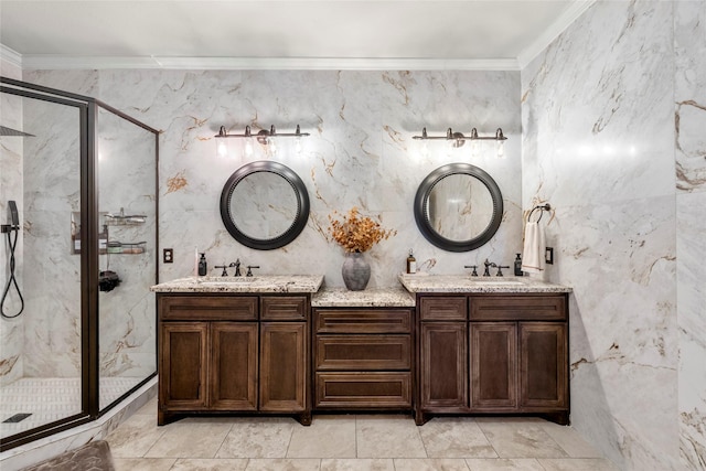 full bathroom featuring double vanity, a sink, a marble finish shower, and crown molding