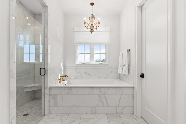 full bathroom featuring marble finish floor, a shower stall, a chandelier, and a bath