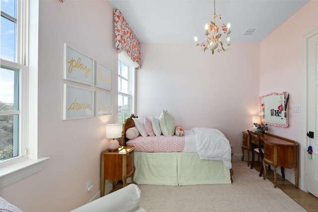 bedroom with visible vents and a notable chandelier