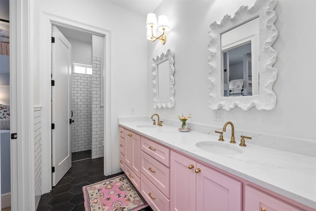 full bath featuring double vanity, a sink, and tile patterned floors