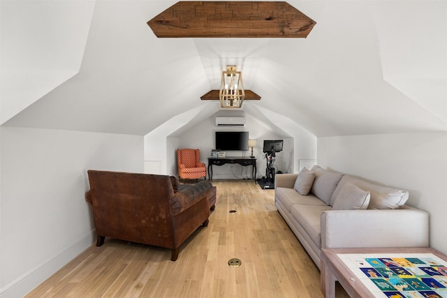 living area with light wood-style floors, a wall unit AC, vaulted ceiling, and baseboards