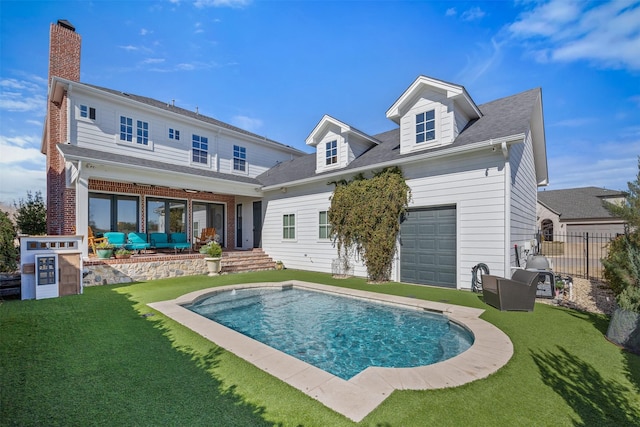 back of house with a yard, a patio area, fence, and brick siding