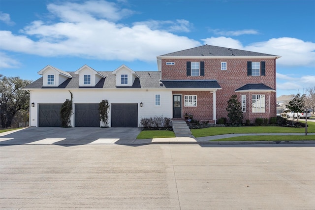 view of front of house featuring concrete driveway, brick siding, an attached garage, and a front yard