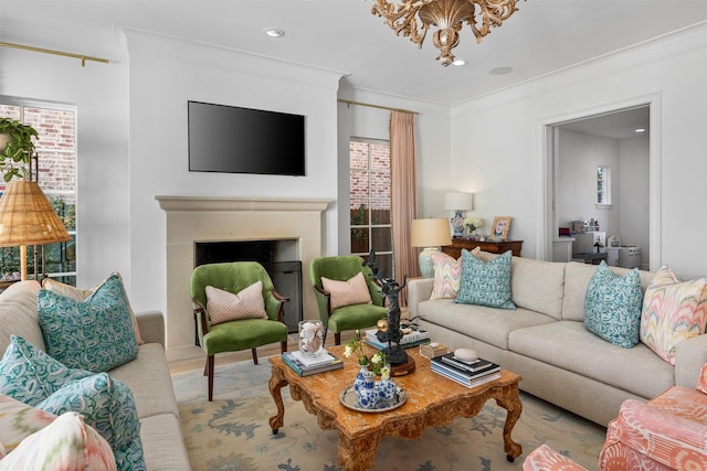 living room with ornamental molding, a fireplace, wood finished floors, and a wealth of natural light