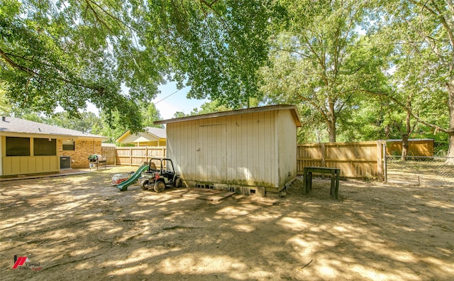 view of shed with a fenced backyard and central air condition unit