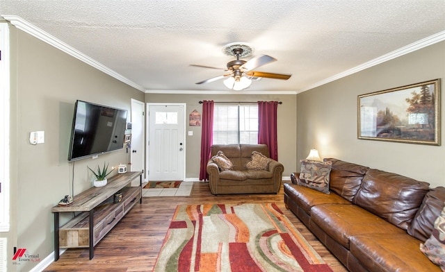 living room featuring a textured ceiling, ornamental molding, wood finished floors, and a ceiling fan