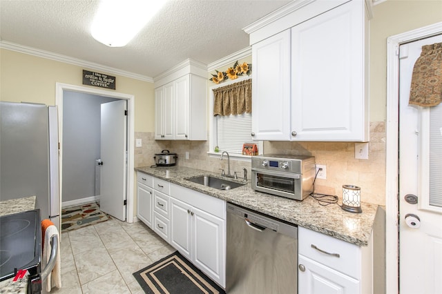 kitchen featuring crown molding, stainless steel appliances, backsplash, white cabinets, and a sink