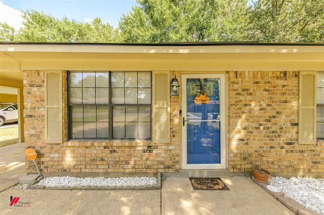 property entrance with brick siding