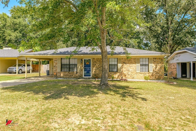 single story home with concrete driveway, a front lawn, a carport, and brick siding