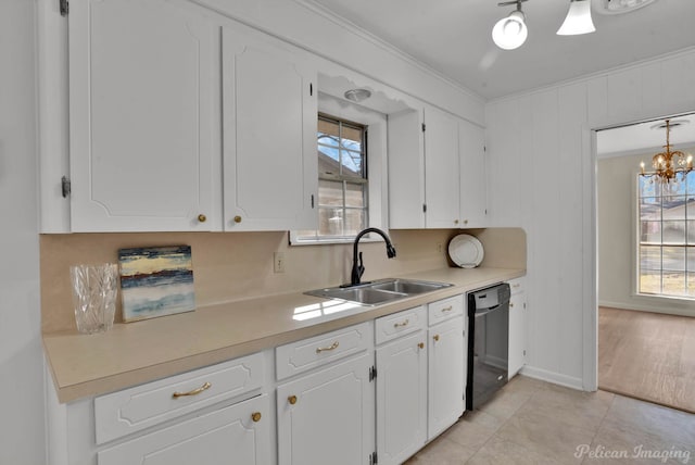 kitchen featuring ornamental molding, white cabinets, black dishwasher, and a sink