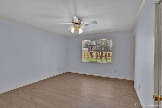 empty room with baseboards, wood finished floors, ornamental molding, and a ceiling fan