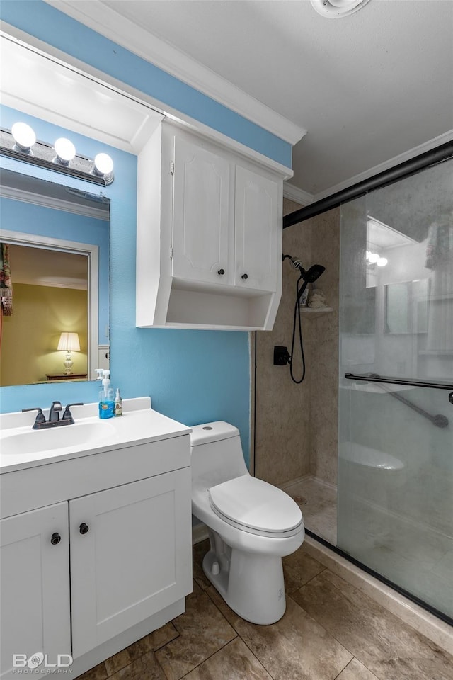 full bathroom featuring vanity, toilet, ornamental molding, and a shower stall