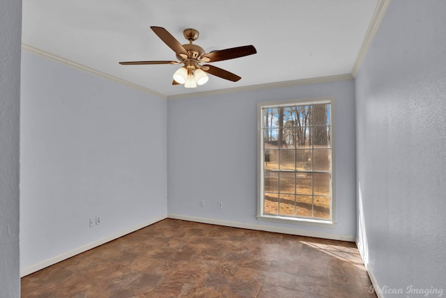 empty room featuring a ceiling fan, baseboards, and ornamental molding