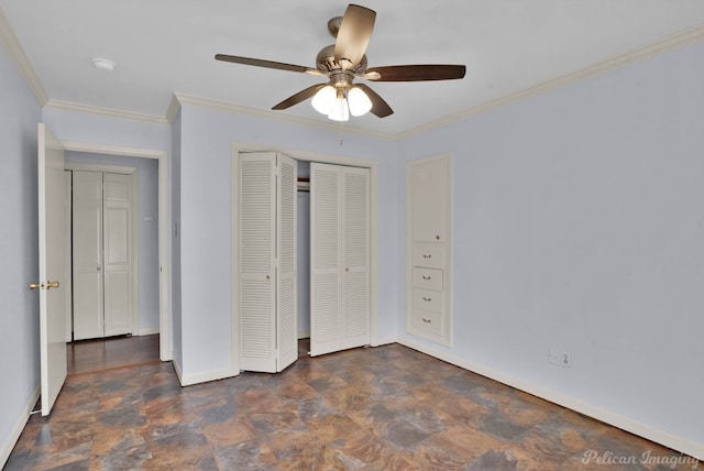 unfurnished bedroom with a ceiling fan, stone finish flooring, a closet, crown molding, and baseboards