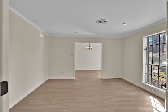 empty room with light wood finished floors, visible vents, baseboards, a chandelier, and ornamental molding