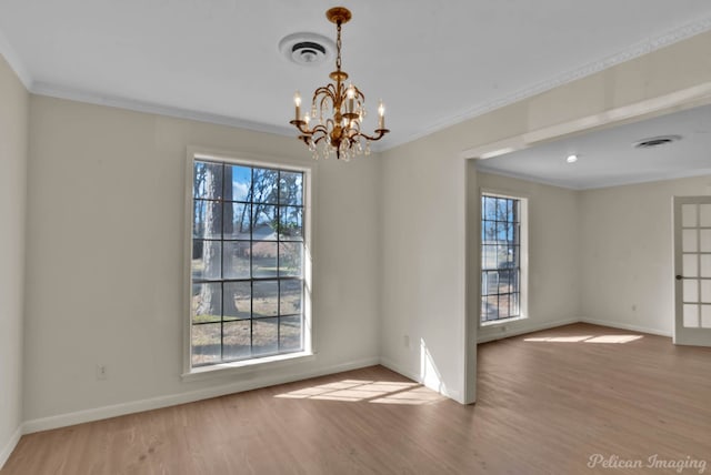 unfurnished room with plenty of natural light, crown molding, and wood finished floors