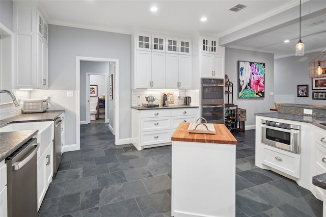 154 Bayside Cir, Malakoff, TX 75148 - kitchen with stainless steel appliances, wooden counters, baseboards, ornamental molding, and glass insert cabinets
