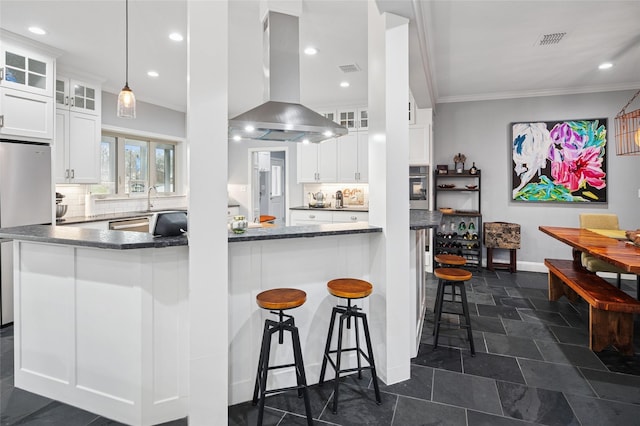 154 Bayside Cir, Malakoff, TX 75148 - kitchen with appliances with stainless steel finishes, island exhaust hood, white cabinets, ornamental molding, and a kitchen breakfast bar