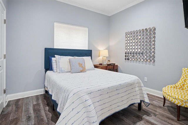 bedroom featuring baseboards, crown molding, and wood finished floors