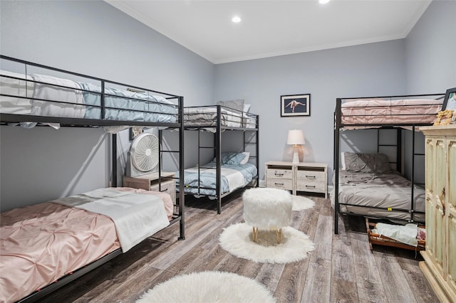 bedroom featuring crown molding, wood finished floors, and recessed lighting